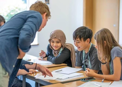teacher helping students in problem solving